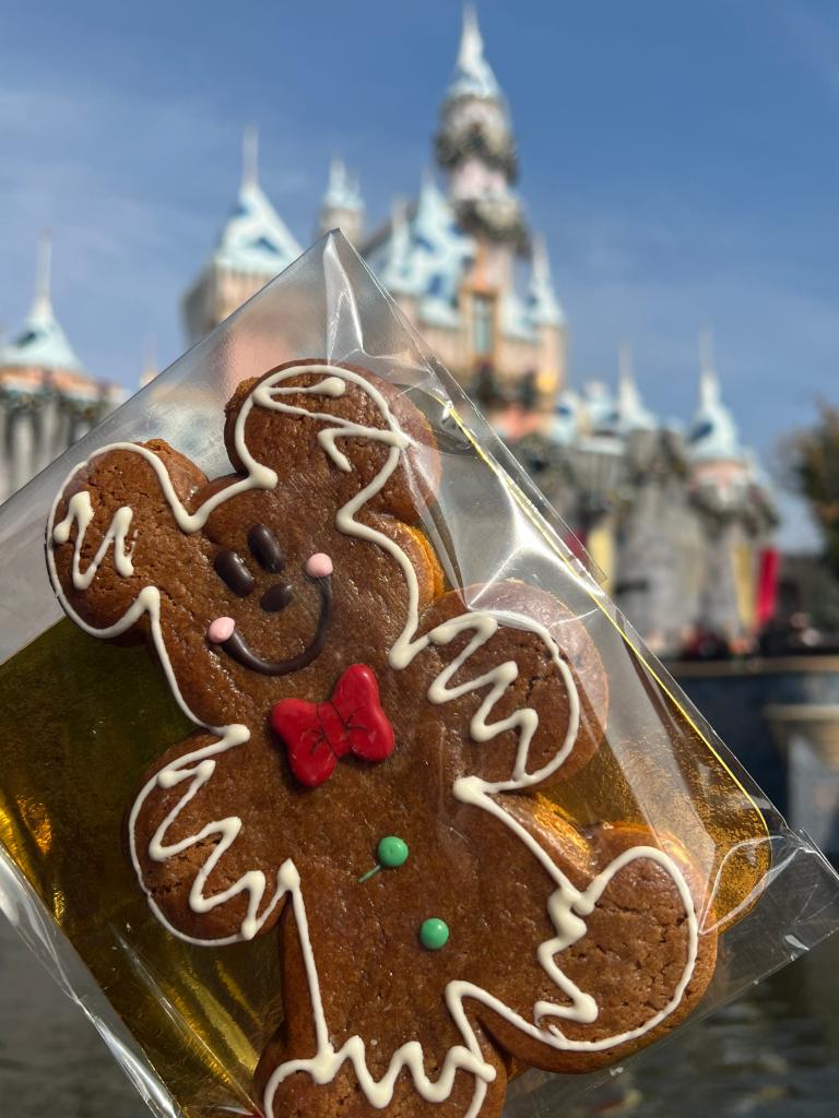 Gingerbread man shaped like Mickey Mouse in plastic wrap, popular holiday treat at Disneyland Resort