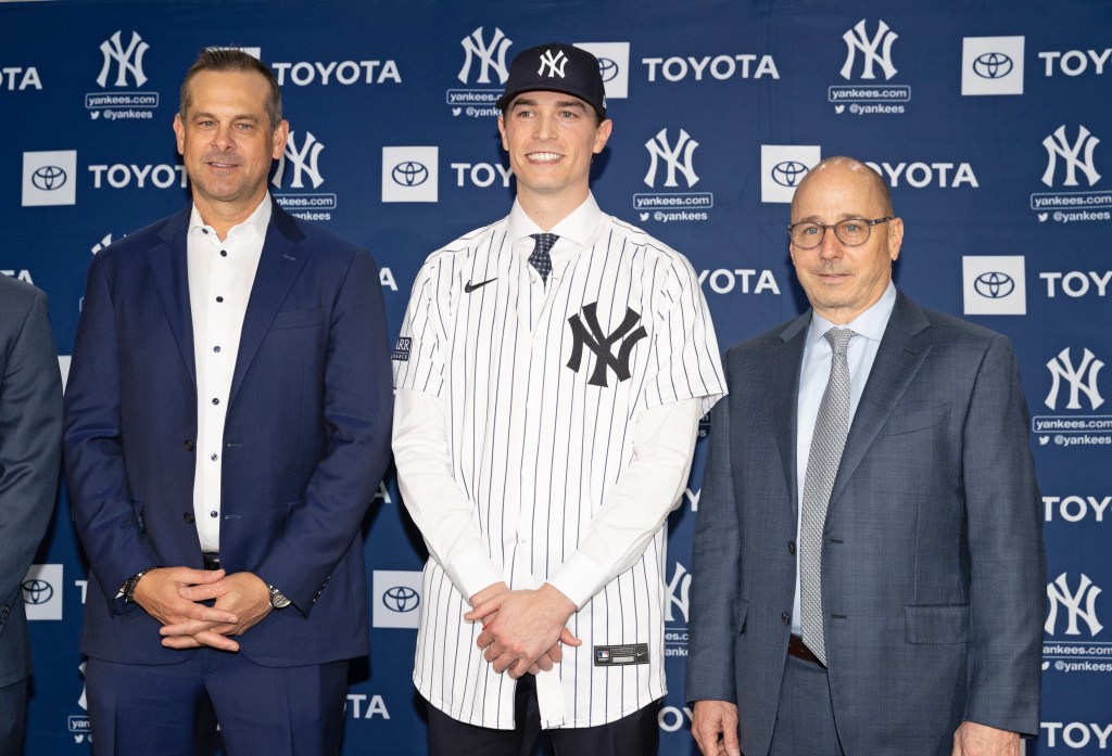 New York Yankees manager Aaron Boone, pitcher Max Fried, and GM Brian Cashman at a press conference in Yankee Stadium on December 18, 2024