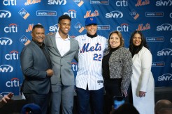 Juan Soto (c.) poses with his family during his Mets introduction at Citi Field on Dec. 12, 2024.