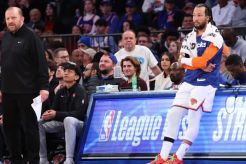 Jalen Brunson waits a the scorer's table to enter the game in the fourth quarter of the Knicks' Christmas Day win over the Spurs as coach Tom Thibodeau looks on.