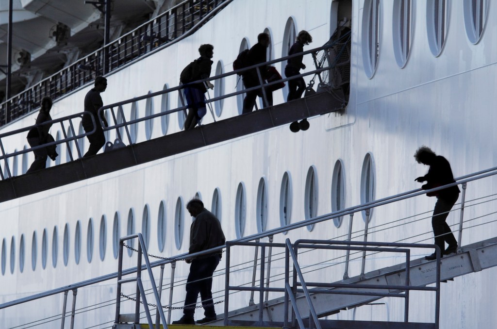 People exiting and entering a cruise liner at Ketchikan, Alaska, with La Parka among them.