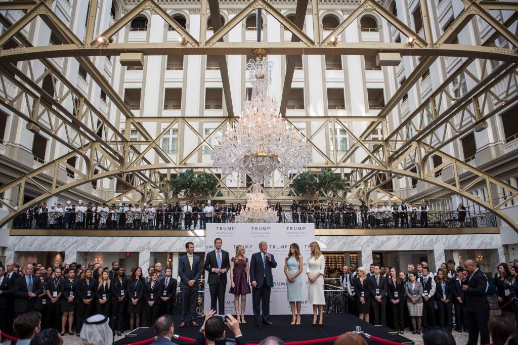 Donald Trump and his family cutting a ribbon at the grand opening of Trump International Hotel in Washington DC in 2016