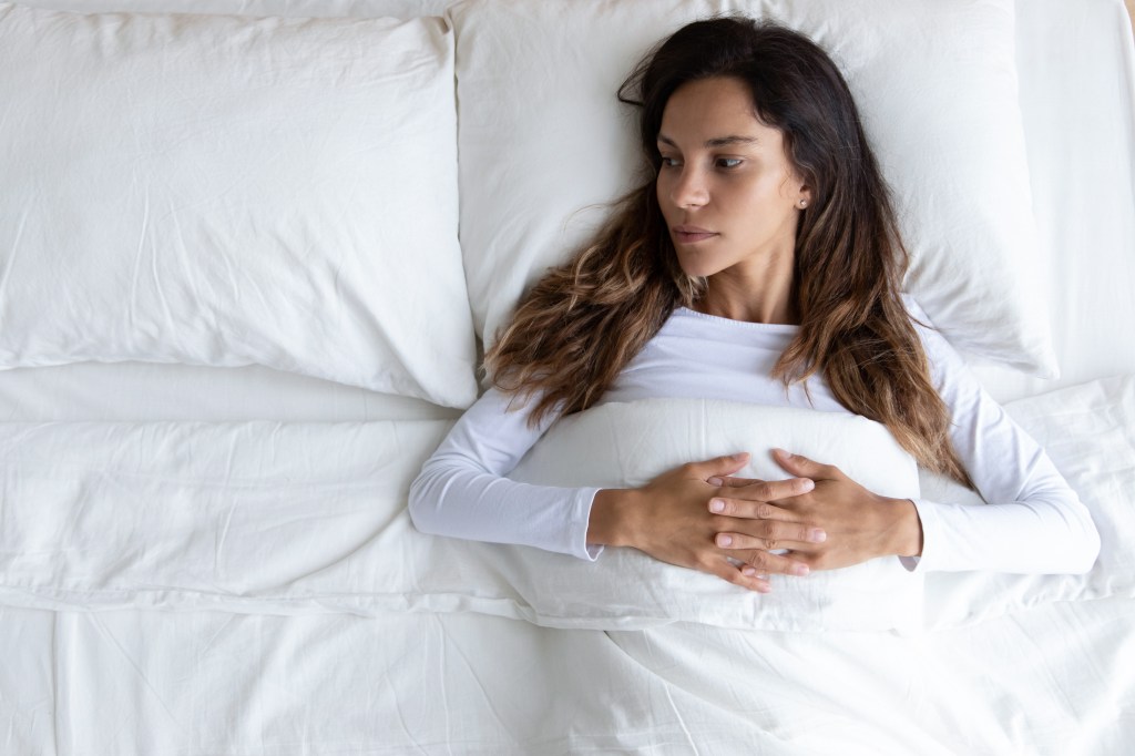 Woman alone in bed.