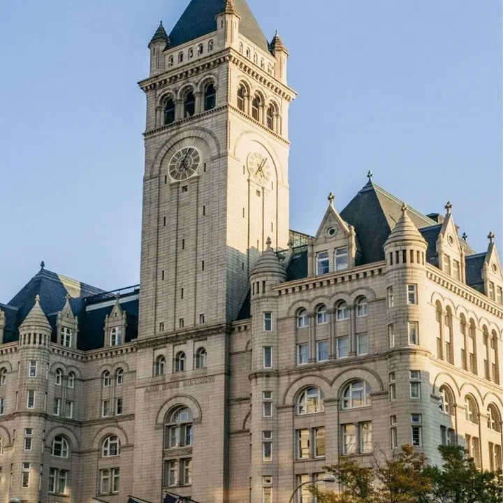 Large building with a clock tower, previously leased by The Trump Organization