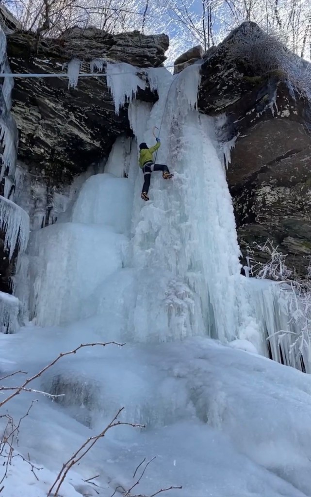 Wawrzyniak climbing up an icy waterfall