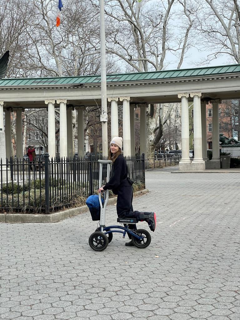 Wawrzyniak using a wheeled walker and crutches to get around