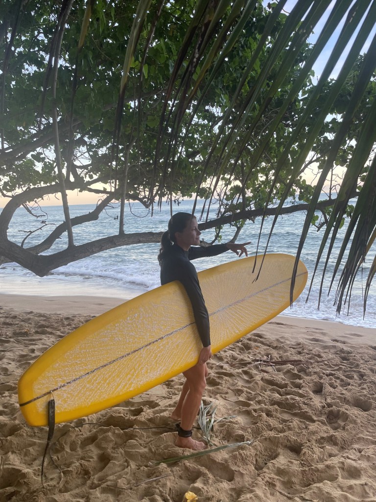 Wawrzyniak pictured with a surfboard on the beach