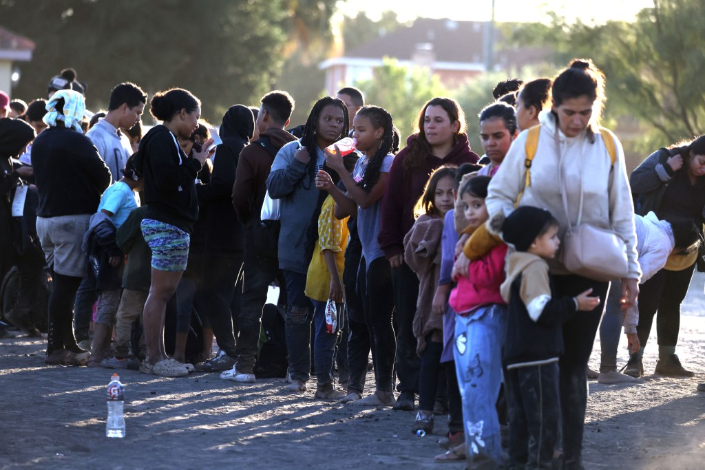 Migrants waiting on line.