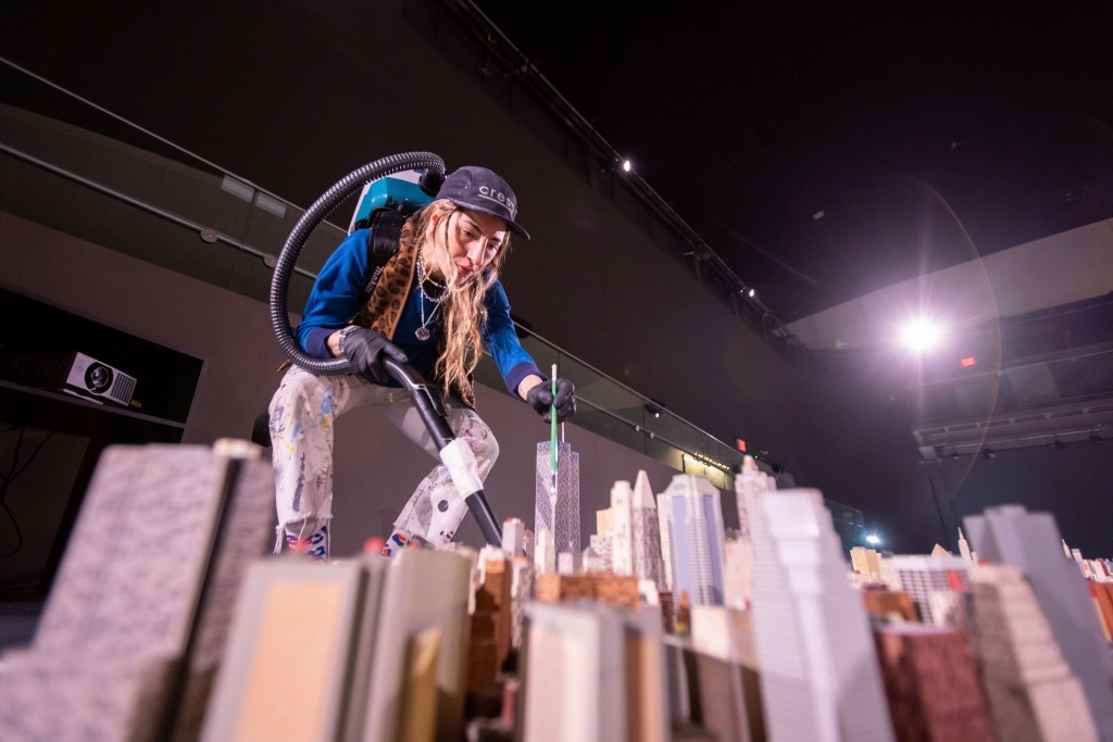 Yezica Tutic artist and art preparator, cleans The Panorama of the City of New York