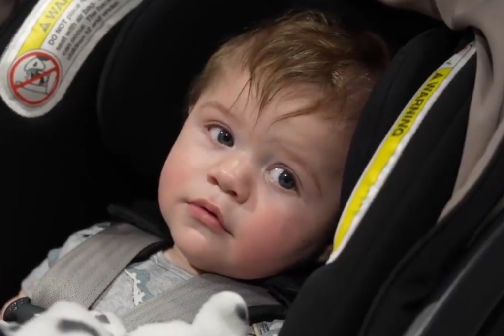 Young Chicago mother expressing gratitude to her medical team, with her baby in a car seat beside her