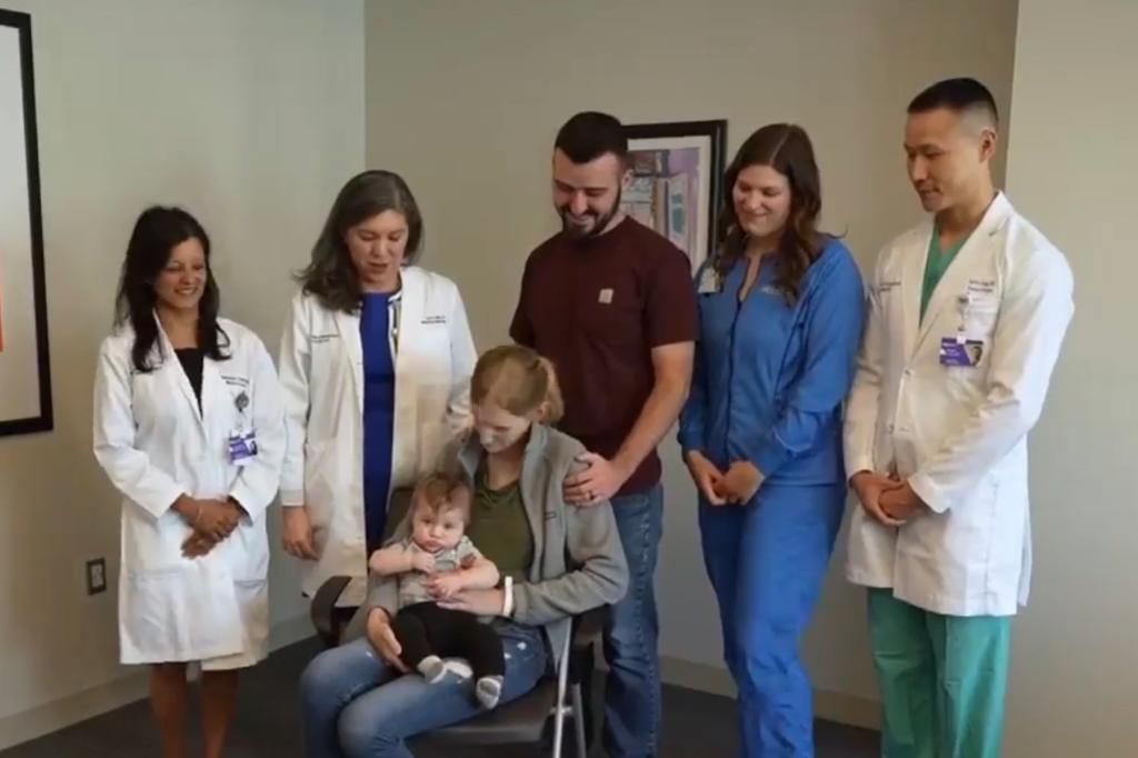 Young Chicago mother expressing gratitude to her medical team, with her baby