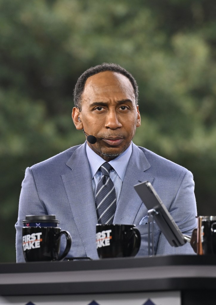 Journalist Stephen A. Smith in a suit, attending ESPN First Take at Clark Atlanta University and Morehouse College with a microphone