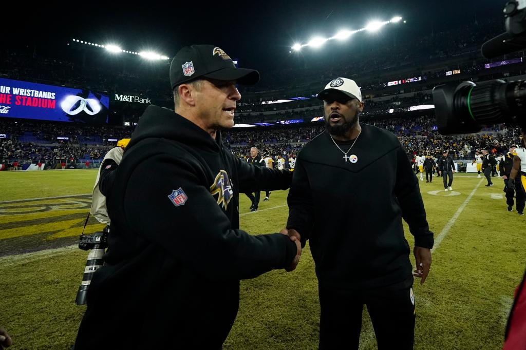 Baltimore Ravens head coach John Harbaugh, left, meets with Pittsburgh Steelers head coach Mike Tomlin following an NFL football game in Baltimore, Fla., Sunday, Jan. 1, 2023. The Steelers defeated the Ravens 16-13. 