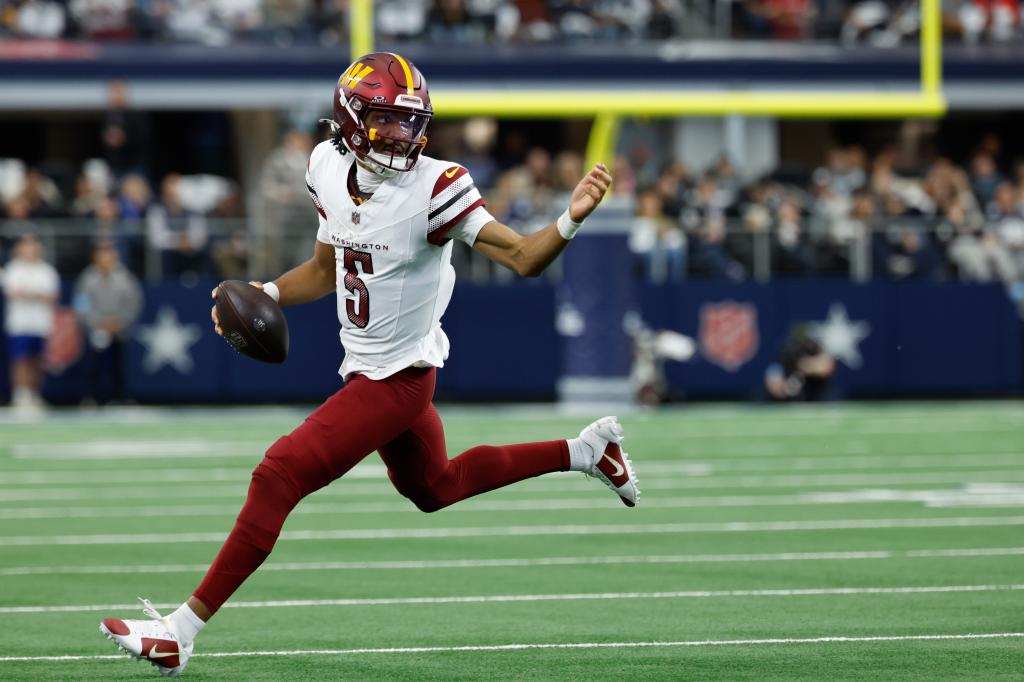 Washington Commanders quarterback Jayden Daniels (5) carries the ball during a NFL football game against the Dallas Cowboys on Sunday, Jan. 5, 2025, in Arlington, Texas. 