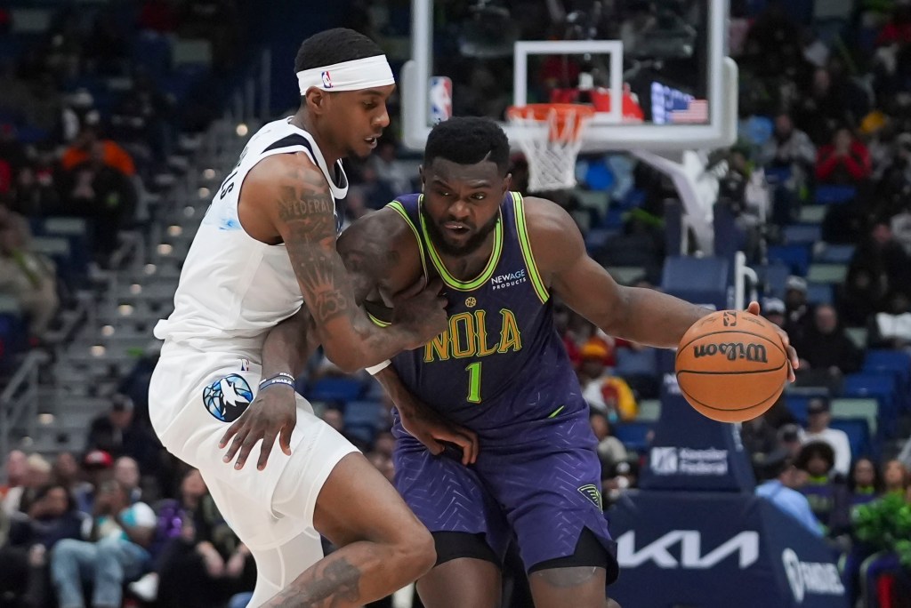 New Orleans Pelicans forward Zion Williamson (1) moves the ball against Minnesota Timberwolves forward Jaden McDaniels in the second half of an NBA basketball game in New Orleans, Tuesday, Jan. 7, 2025. 