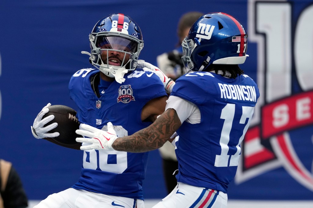 Giants wide receiver Darius Slayton (86) celebrates with Wan'Dale Robinson (17) after Slayton scored a touchdown against the Indianapolis Colts in the first half of an NFL football game Sunday, Dec. 29, 2024.