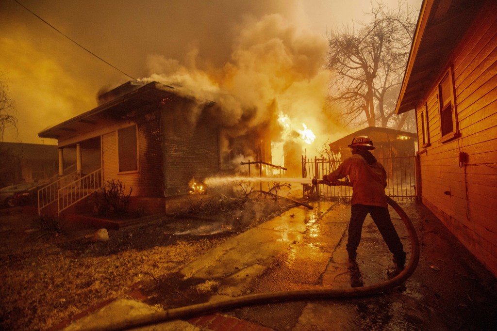 A firefighter battles the Eaton Fire Wednesday, Jan. 8, 2025 in Altadena, Calif.