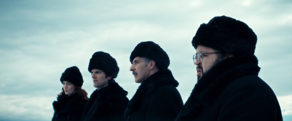 Britt Lower, Adam Scott, John Turturro, and Zach Cherry in "Severance" Season 2 standing in a line wearing fluffy hats. 