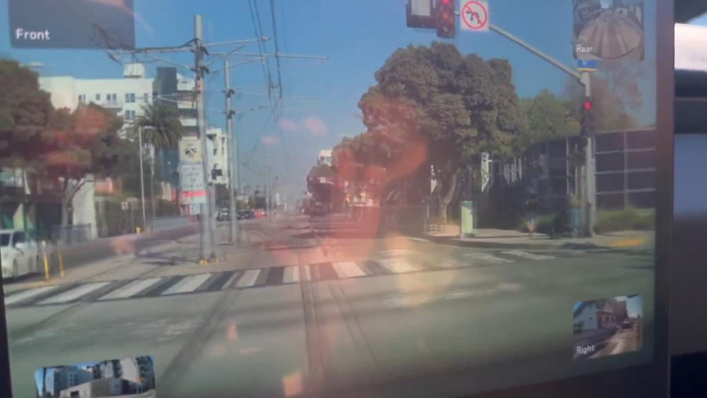 A screengrab from the video, showing the car driving over the train tracks.