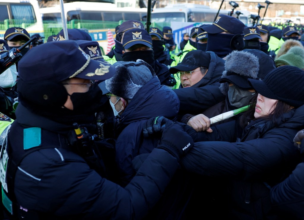 Supporters of impeached South Korean President Yoon Suk Yeol scuffle with police during an attempted arrest in Seoul, South Korea.