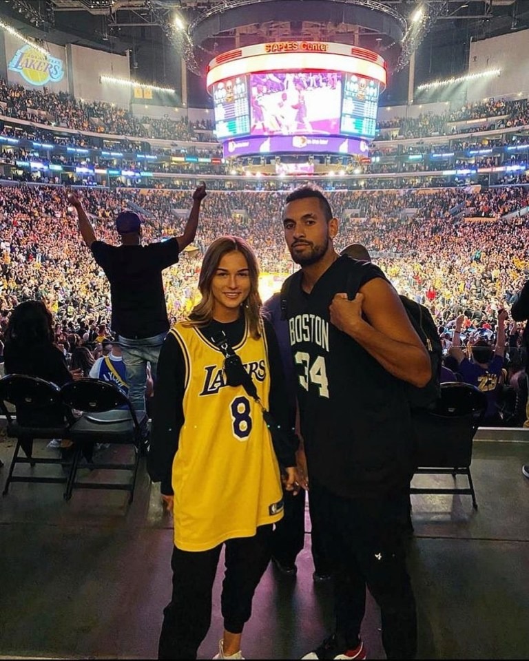 Nick Kyrgios and Anna Kalinskaya posing for a picture in a stadium