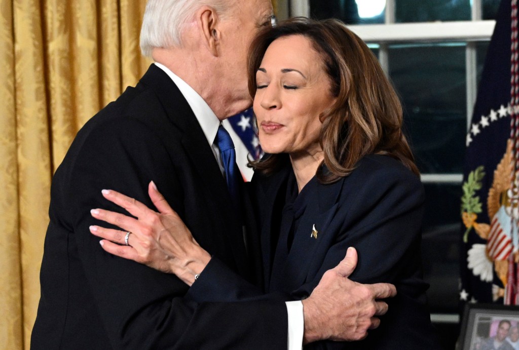 Biden embraces Vice President Kamala Harris following his speech.