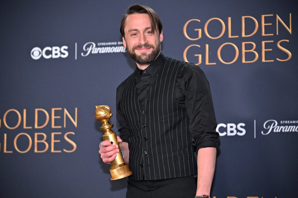 Kieran Culkin holding a golden globe