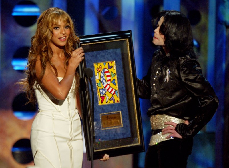 LAS VEGAS - OCTOBER 27: (TABLOIDS OUT) Singer Beyonce' Knowles presents singer Michael Jackson with the 2003 Humanitarian Award onstage at The 2003 Radio Music Awards at the Aladdin Casino Resort October 27, 2003 in Las Vegas, Neveda. For more information on Jackson's humanitarian efforts, go to musicforgiving.org. (Photos by Kevin Winter/Getty Images)