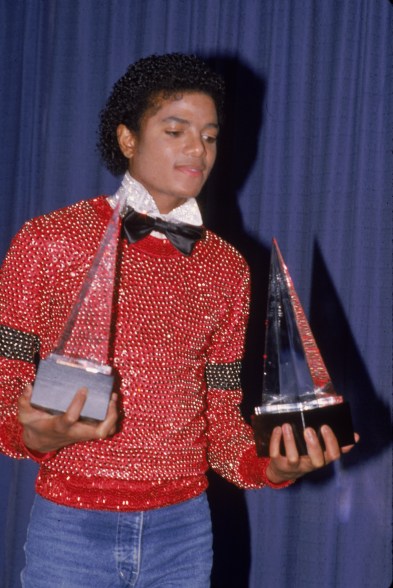 American pop singer Michael Jackson carries the two American Music Awards he won for his album 'Off the Wall,' they are for Favorite Male Vocalist - Soul and R&B, and Favorite Album - Soul and R&B, Los Angeles, January 30, 1981. (Photo by Frank Edwards/Getty Images)