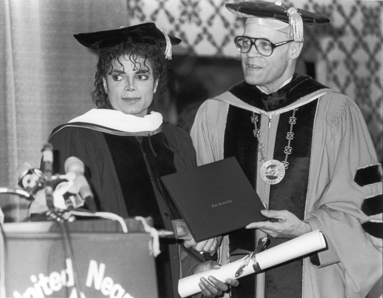 Popular American musician Michael Jackson (1958 ? 2009) left) poses with educator Henry Ponder, President of Fisk University, who presented Jackson with an honorary doctorate in human letters at the 44th anniversary dinner of the United Negro College Fund at the Sheraton Centre, New York, New York, March 10, 1988.(Photo by Hulton Archive/Getty Images)