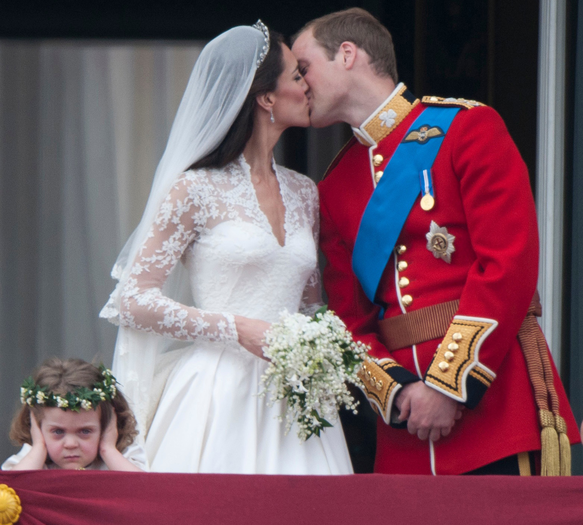 Kate Middleton and Prince William share a kiss on their wedding day on the balcony at Buckingham Palace.