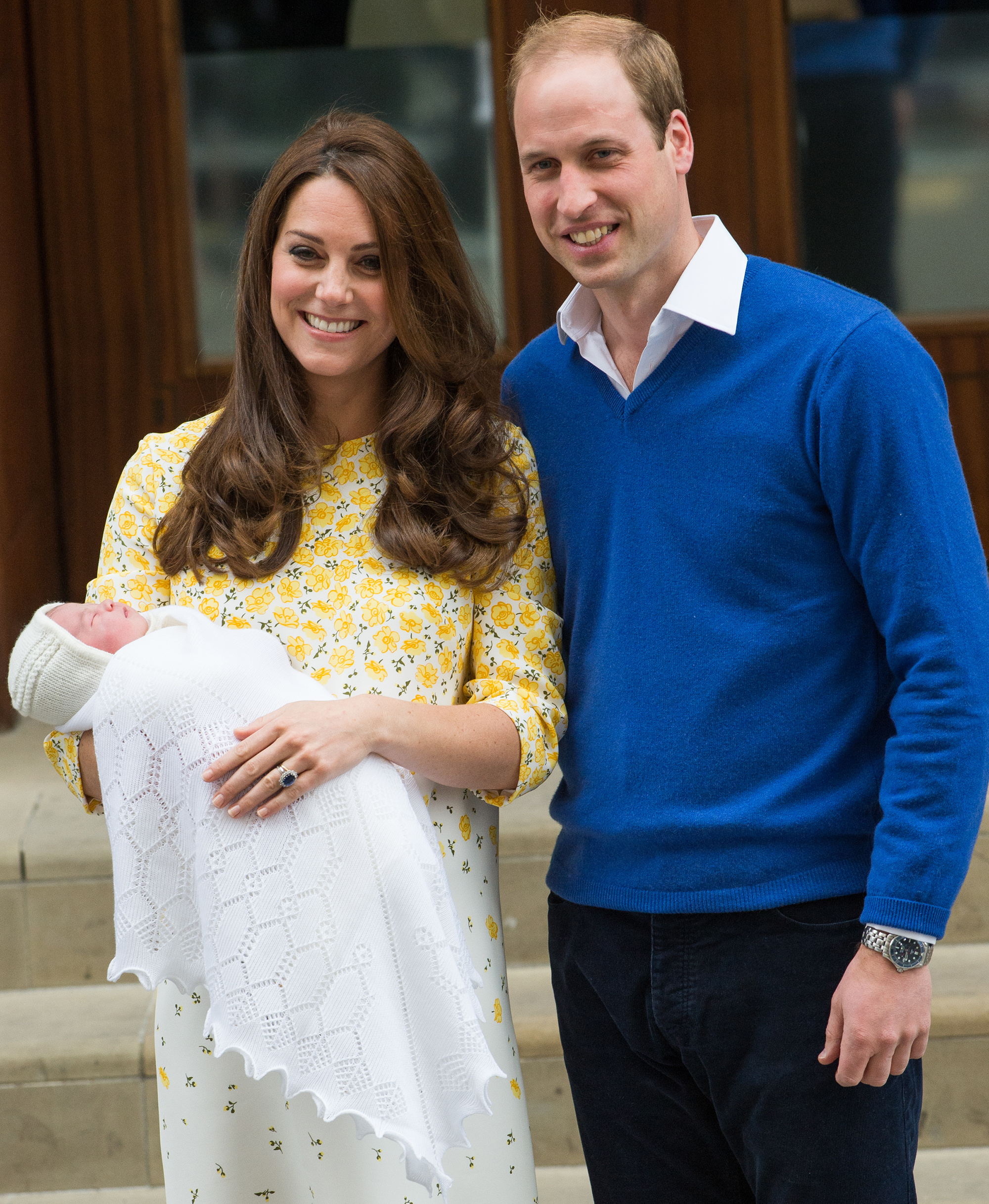 Kate Middleton and Prince William pose with daughter Princess Charlotte.