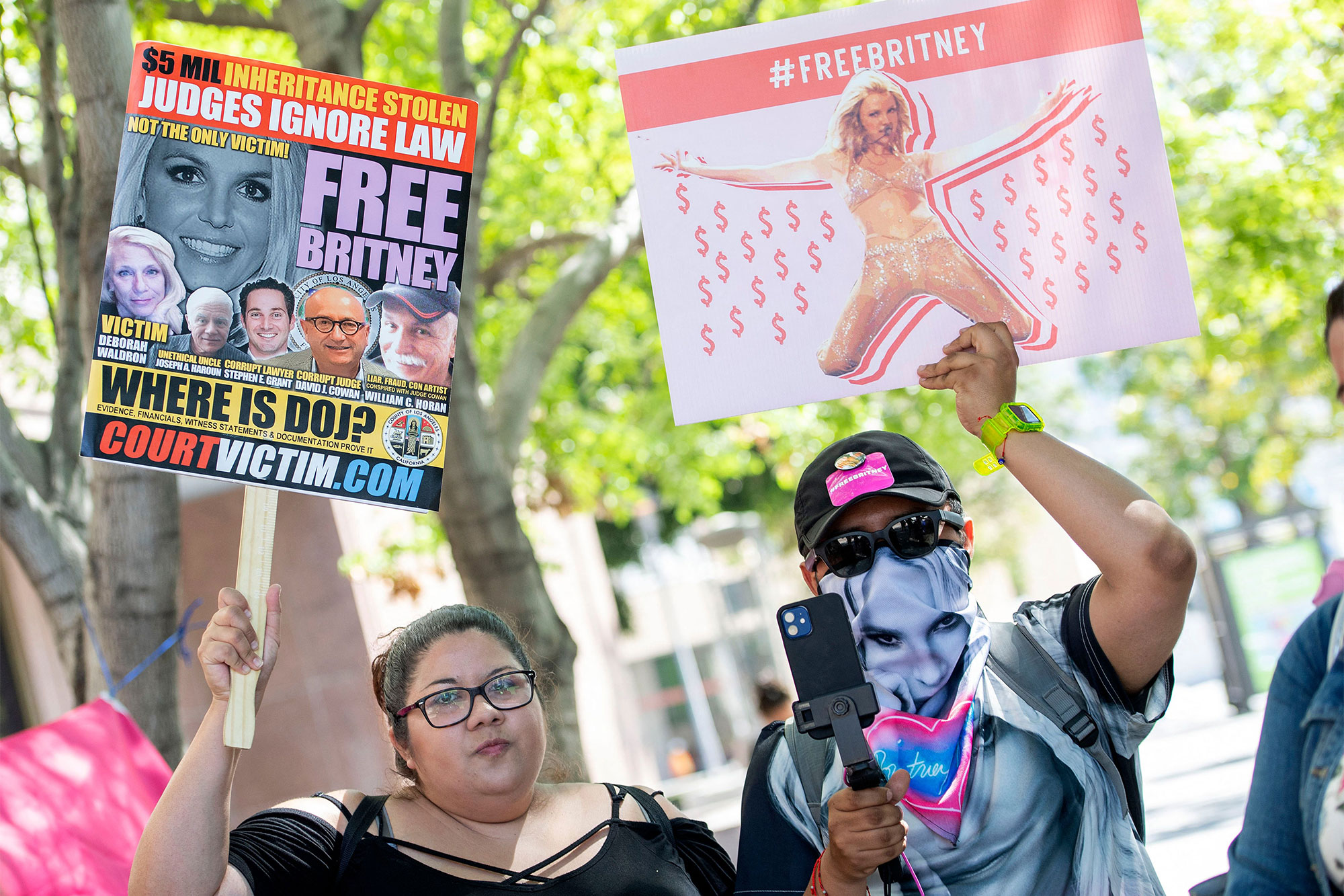 Fans and supporters of Britney Spears hold "Free Britney" signs as they gather outside the Los Angeles County Courthouse during a scheduled hearing in the Britney Spears guardianship case, in Los Angeles, California, July 19, 2021.