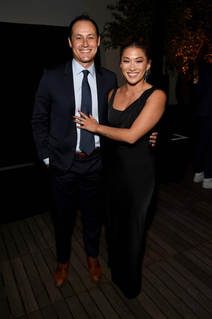 Jenna Ushkowitz and David Stanley on a red carpet.