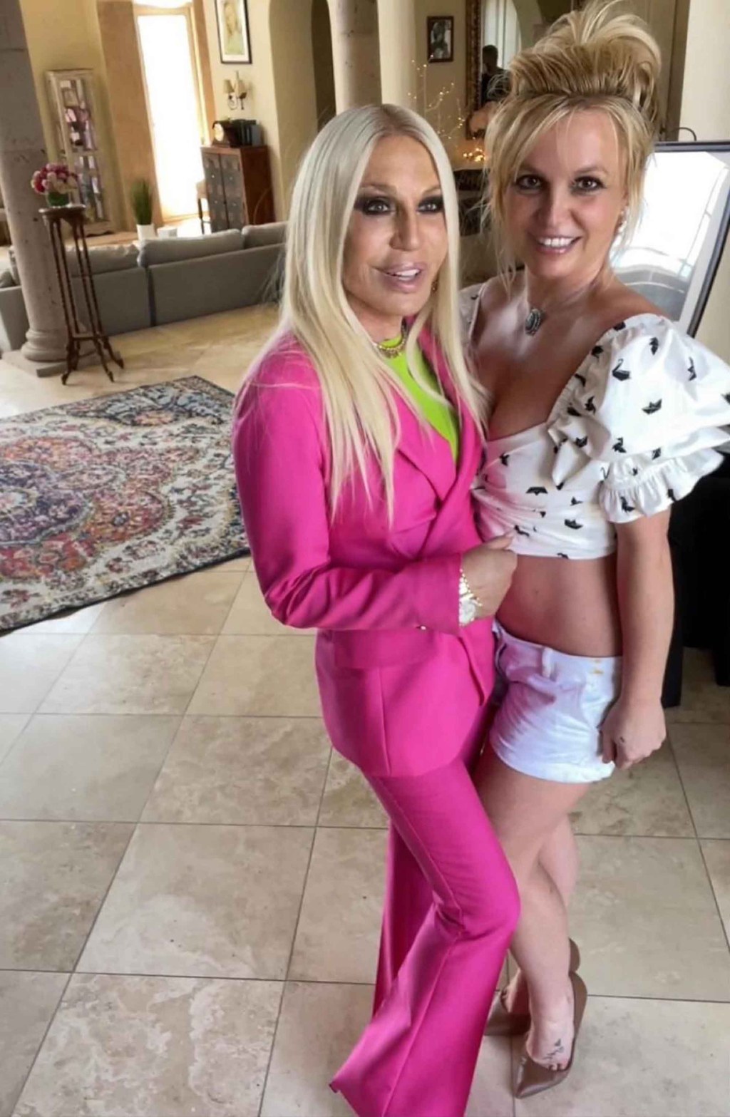 Donatella Versace and Britney Spears posing together.