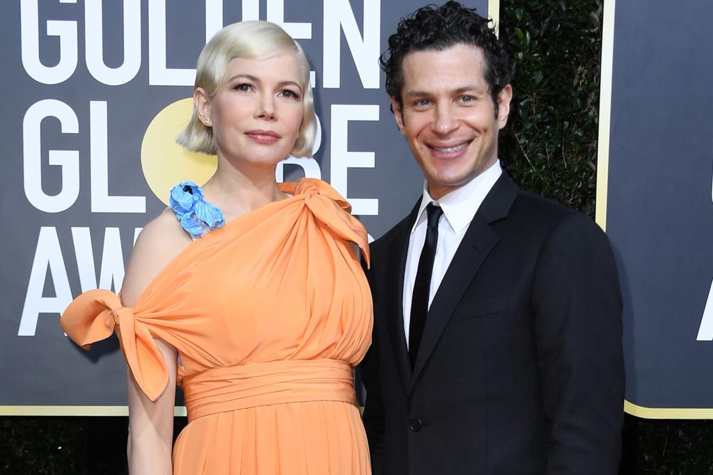 Michelle Williams and Thomas Kail on a red carpet.