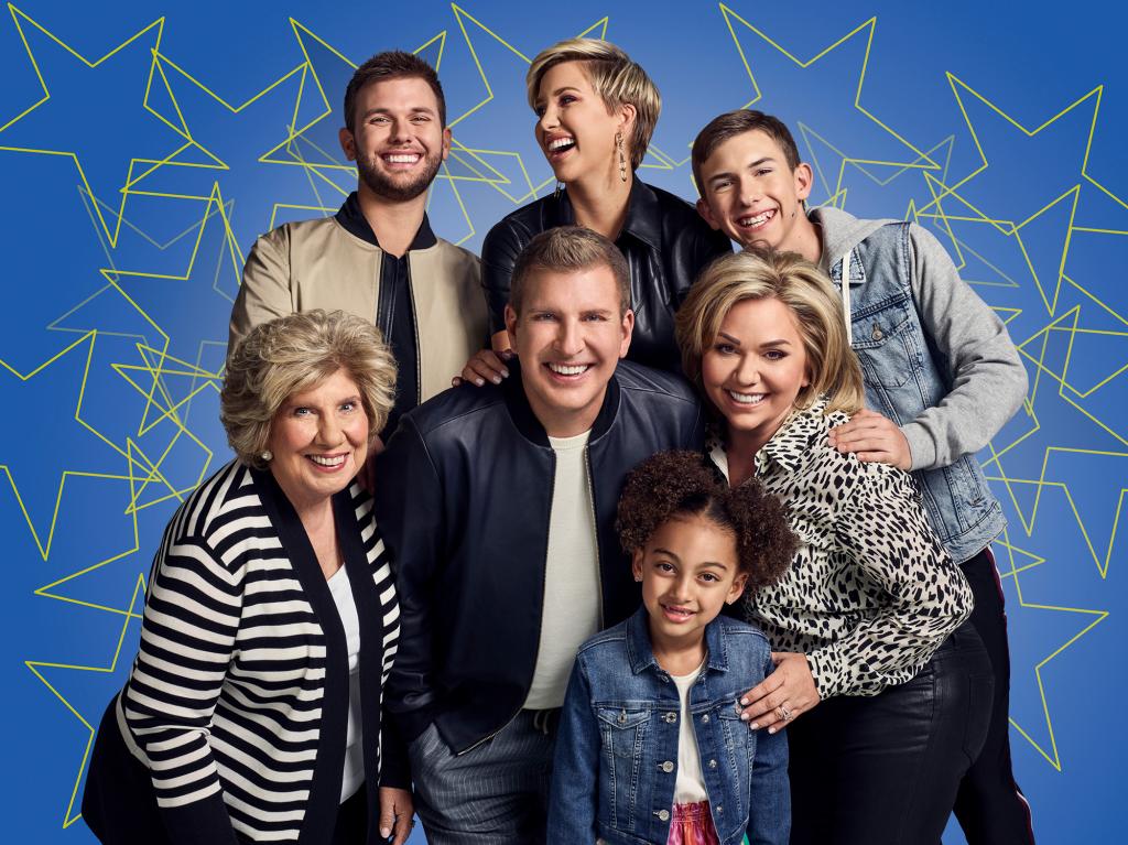 Faye Chrisley, Chase Chrisley, Todd Chrisley, Savannah Chrisley, Chloe Chrisley, Julie Chrisley, and Grayson Chrisley posing for a family photo together.