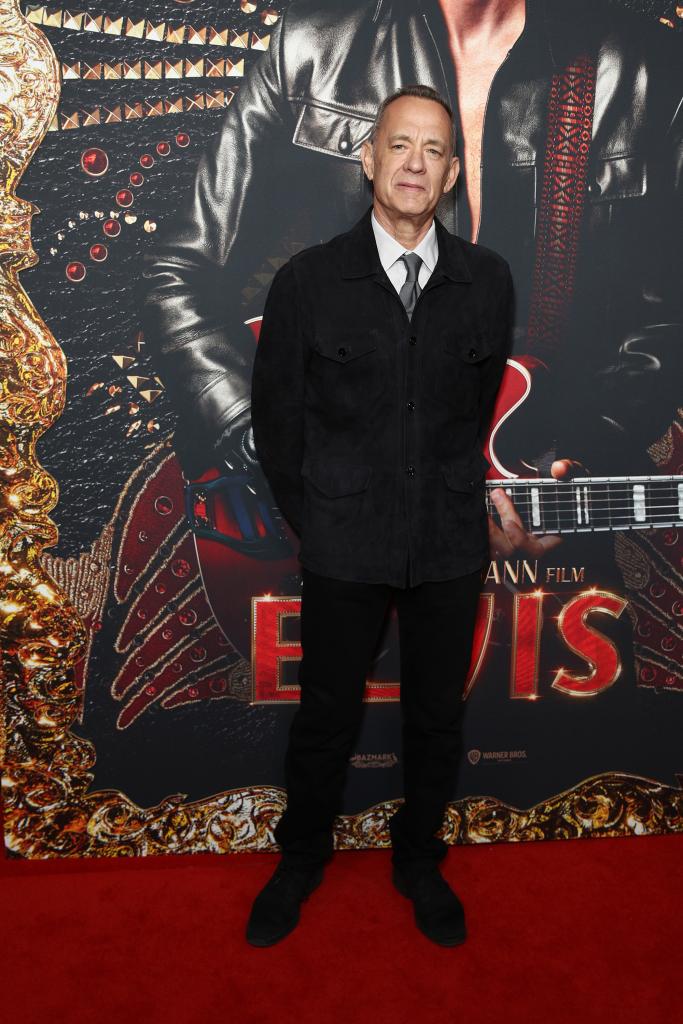 Tom Hanks posing on the red carpet at the "Elvis" premiere.