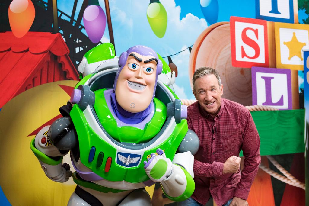 Tim Allen posing with Buzz Lightyear.