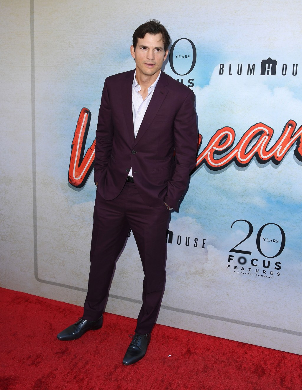 Ashton Kutcher on a red carpet in July 