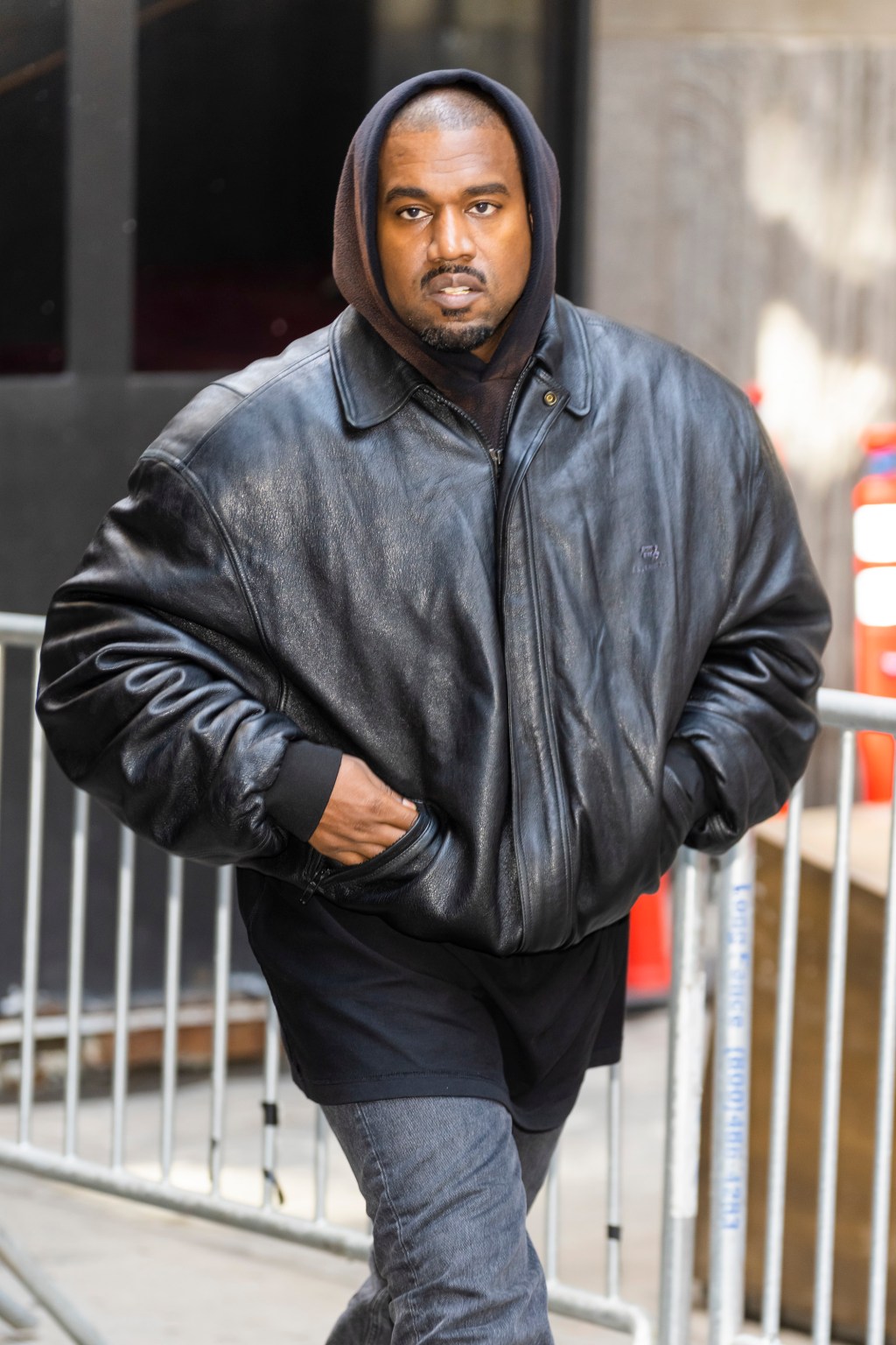 Kanye West walking in the street.