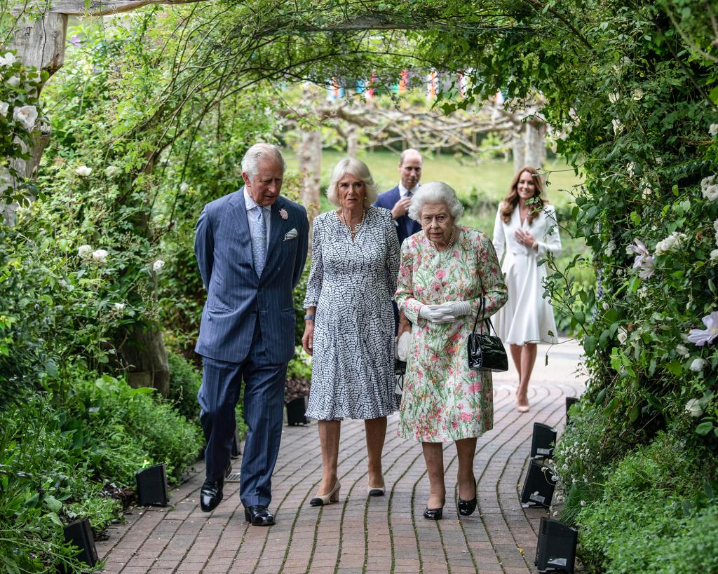 Queen Elizabeth II walking with Prince Charles and Duchess Camilla