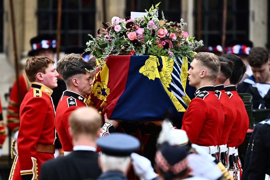 queen elizabeth ii's casket with flowers being carried