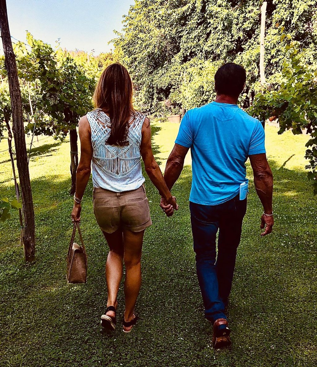 Sylvester Stallone and Jennifer Flavin holding hands while on a walk