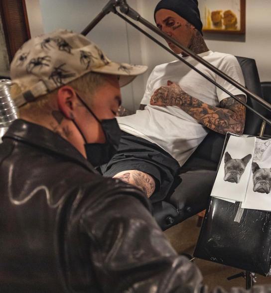 Dr. Woo tattooing Travis Barker