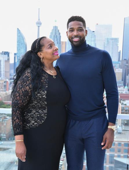 Andrea Thompson looking up at Tristan Thompson for a picture.