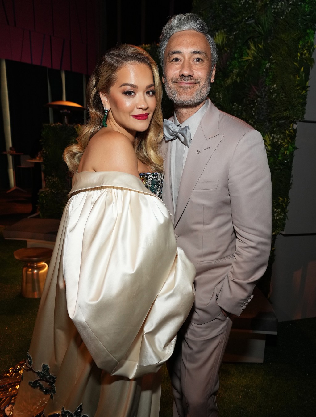 Rita Ora and Taika Waititi posing together at an event.