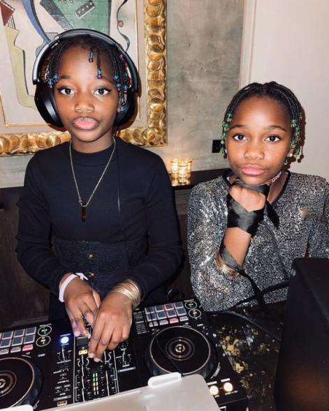 Stella and Estere pose for a pic behind turntables