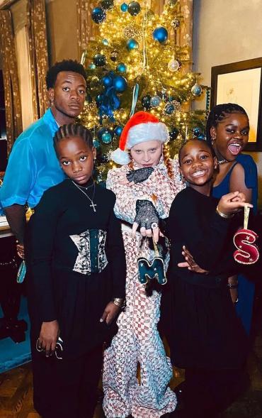 Madonna poses in front of Christmas tree with David, Mercy, Stella and Estere