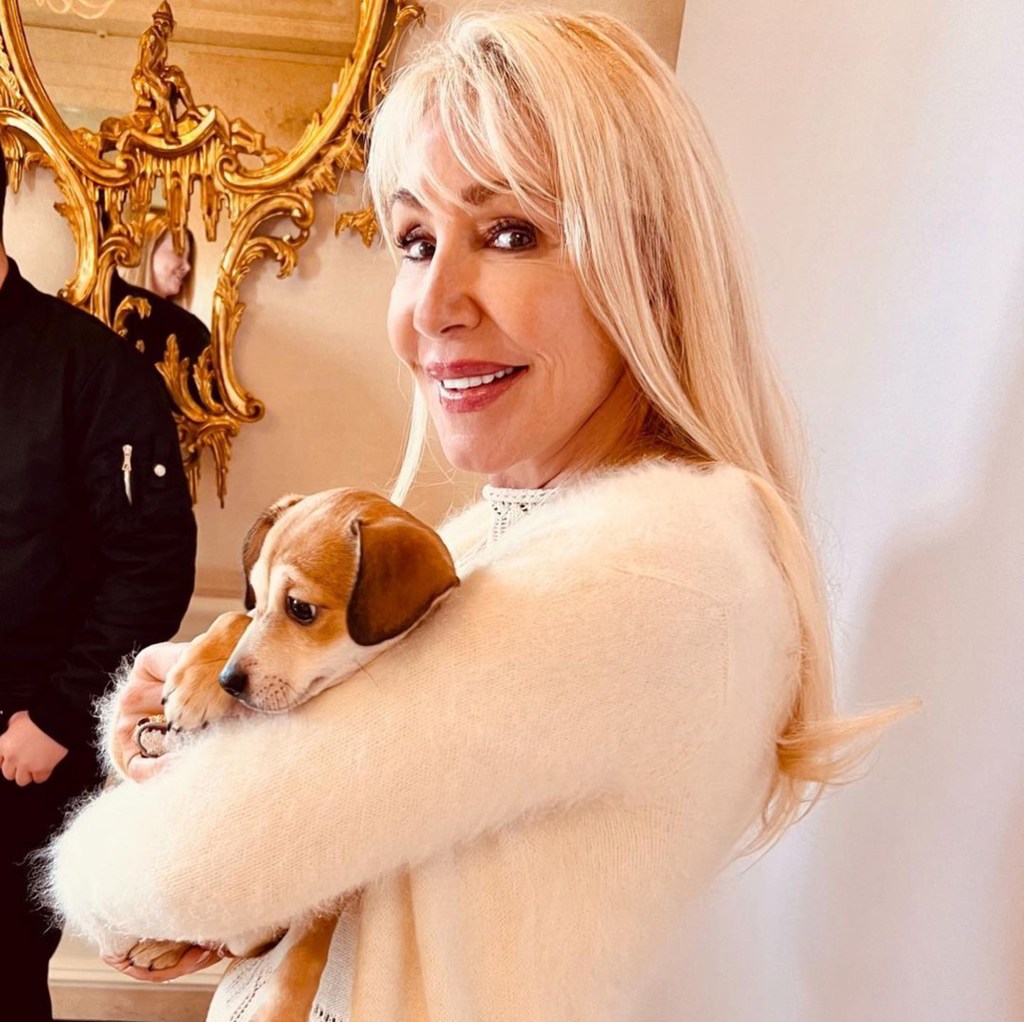 Linda Thompson holding a dog.